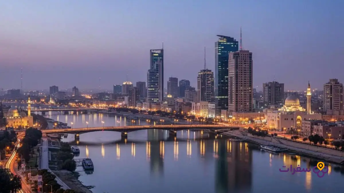 best 5 star hotels baghdad 3 أفق مدينة بغداد عند الغسق مع الأضواء المتلألئة.