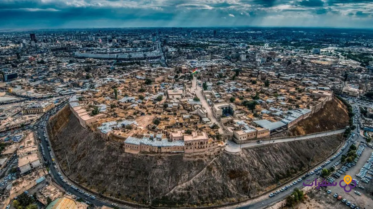 erbil tourist places travel guide 1 4 لقطة جوية لقلعة أربيل الأثرية تظهر حجمها وتفاصيلها المعمارية في وضح النهار.