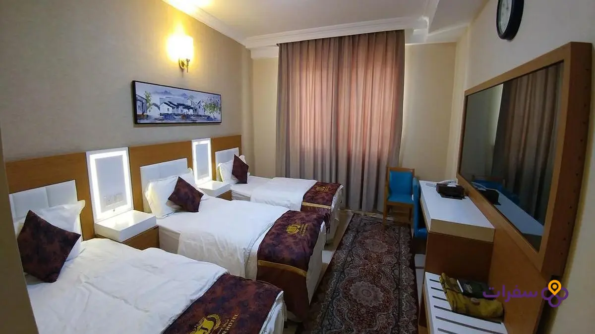 A hotel in Karbala with the shrine of Imam Hussein visible in the background.